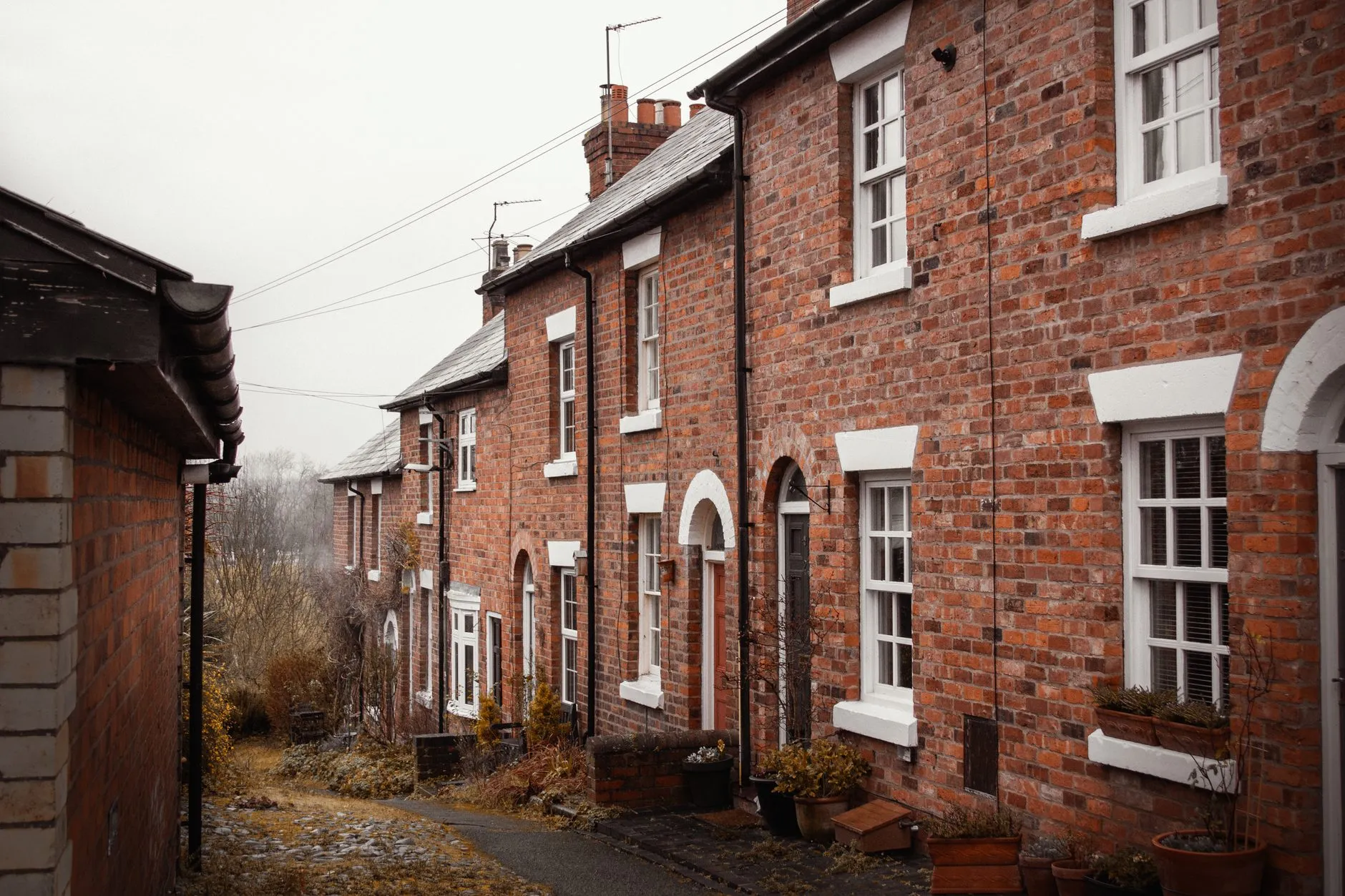 A lane of red-brick terraced houses with white sash windows, the kind of street many of our clients live and work on